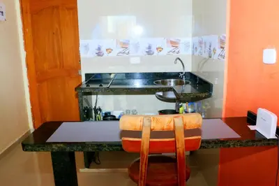 a kitchen with a counter with a sink and a stool at Loft sea view 11C air and wifi in Cartagena de Indias