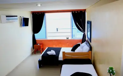 a small room with a bed and a window at Loft sea view 19C air and wifi in Cartagena de Indias