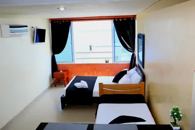 a bedroom with two beds and a large window at Loft sea view 19C air and wifi in Cartagena de Indias