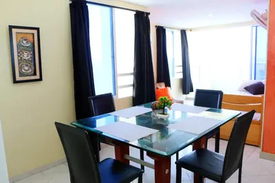 a dining room with a table and chairs and a bedroom at Sea View Apartment 1-19C Air Wifi in Cartagena de Indias