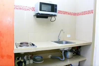 a kitchen with a sink and a tv on a shelf at Sea View Apartment 1-19C Air Wifi in Cartagena de Indias