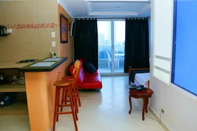 a room with a kitchen with a sink and a bed at Sea View Apartment 1-11C air wifi in Cartagena de Indias