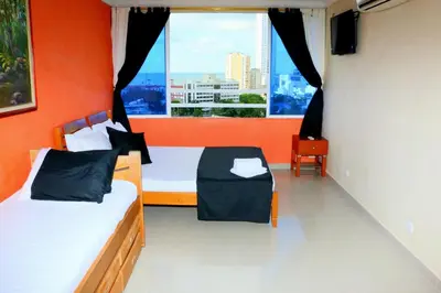 a bedroom with two beds and a large window at Sea View Apartment 1-11C air wifi in Cartagena de Indias