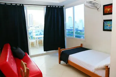 a bedroom with a bed and a large window at Sea View Apartment 1-11C air wifi in Cartagena de Indias
