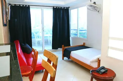 a small bedroom with a bed and a window at Sea View Apartment 1-11C air wifi in Cartagena de Indias