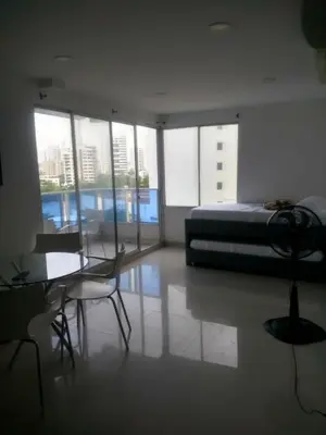a bedroom with a bed and a table and chairs at Sea View Apartment 1-5C air wifi in Cartagena de Indias
