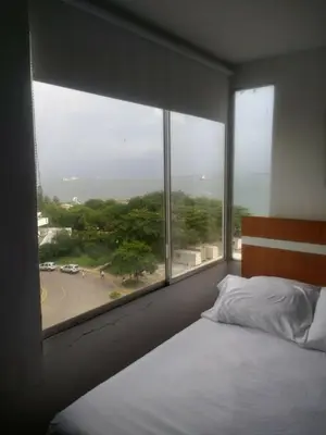 a bedroom with a bed and a large window at Sea View Apartment 1-5C air wifi in Cartagena de Indias