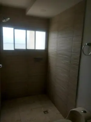 a bathroom with a shower and a door with a window at Sea View Apartment 1-5C air wifi in Cartagena de Indias