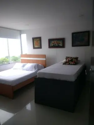 two twin beds in a bedroom with a window at Sea View Apartment 1-5C air wifi in Cartagena de Indias