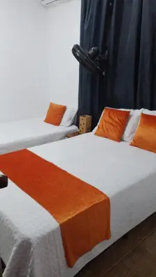 two beds sitting next to each other in a room at Hotel Campestre Maguey in Mangue