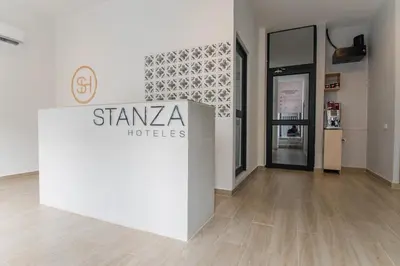 a white wall with a sign in a room at Stanza Hotel Sincelejo in Sincelejo