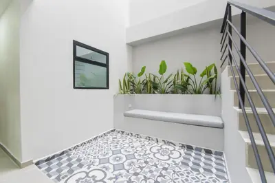 a staircase with a black and white tile floor at Stanza Hotel Sincelejo in Sincelejo