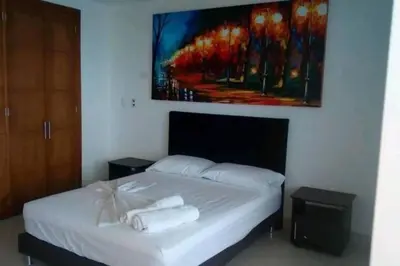 a bedroom with a bed with two towels on it at Cartagena De Indias in Cartagena de Indias