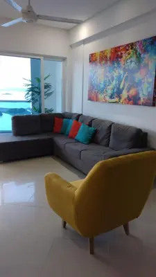 a living room with a couch and a yellow chair at Cartagena De Indias in Cartagena de Indias