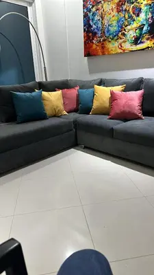 a black couch with four colorful pillows on it at Cartagena De Indias in Cartagena de Indias