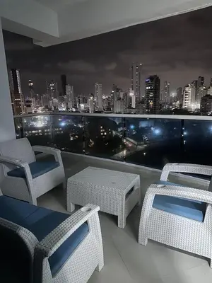 a balcony with chairs and tables and a city skyline at Cartagena De Indias in Cartagena de Indias