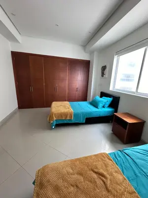 a bedroom with two beds and a window at Cartagena De Indias in Cartagena de Indias