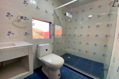 a bathroom with a toilet and a sink and a shower at Villa Santos Apartaestudios in Barranquilla