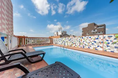 a pool on the roof of a building at Villa Santos Apartaestudios in Barranquilla