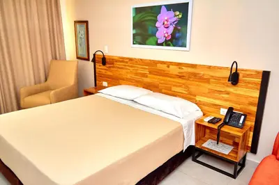a hotel room with a bed and a telephone at Hotel Torre del Prado in Barranquilla