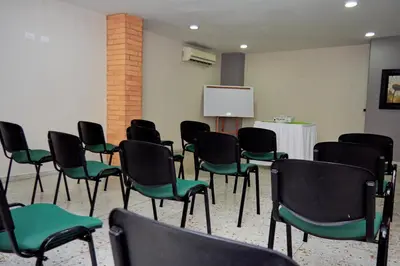 a conference room with chairs and a white board at Hotel Torre del Prado in Barranquilla