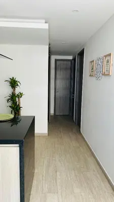 a room with a hallway with white walls and a table at A un Paso de la Playa in Cartagena de Indias