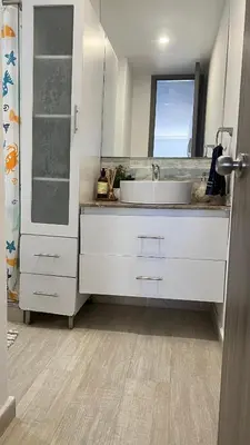 a white bathroom with a sink and a window at A un Paso de la Playa in Cartagena de Indias