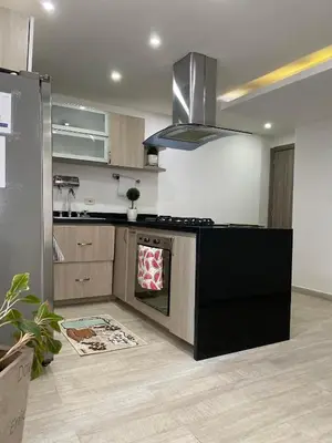 a kitchen with a stove top oven in a room at A un Paso de la Playa in Cartagena de Indias