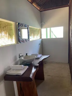 a bathroom with a sink and a mirror on a counter at Isla Única- Islas del Rosario in Isla Grande