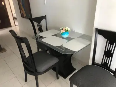 a black table with chairs and a vase of flowers on it at Cartagena Escape Plaza in Cartagena de Indias