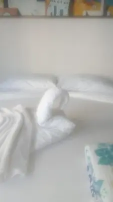a white bed with a white blanket and a cake at Cartagena Escape Plaza in Cartagena de Indias