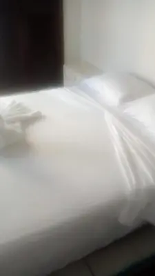 a close up of a bed with white sheets at Cartagena Escape Plaza in Cartagena de Indias