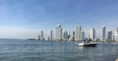a boat in the water in front of a city at Cartagena Escape Plaza in Cartagena de Indias