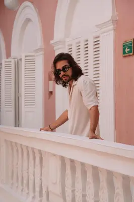 a man standing on the ledge of a balcony at CASA MOVIDA HOSTEL in Cartagena de Indias