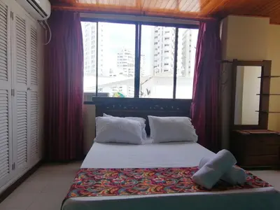 a bedroom with a bed with a large window at Apartahotel Isla Fuerte Piso 4 in Cartagena de Indias