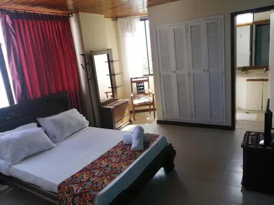 a bedroom with a bed with a teddy bear sitting on it at Apartahotel Isla Fuerte Piso 4 in Cartagena de Indias
