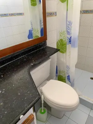 a bathroom with a toilet and a sink and a mirror at Apartahotel Isla Fuerte Piso 4 in Cartagena de Indias