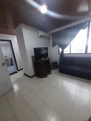 a living room with a couch and a television at Apartahotel Isla Fuerte Piso 4 in Cartagena de Indias