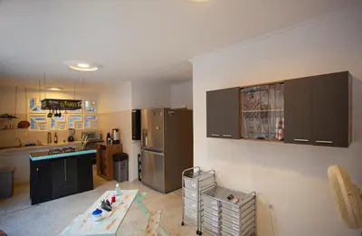 a kitchen with a counter and a refrigerator at Hostal El Bando in Cartagena de Indias