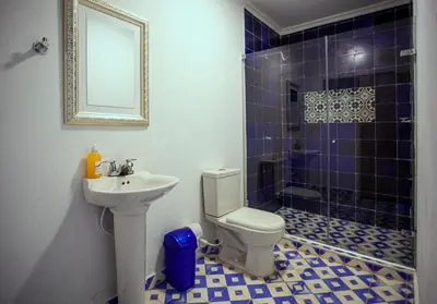 a bathroom with a sink and a toilet and a shower at Hostal El Bando in Cartagena de Indias