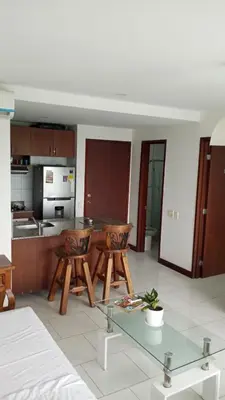 a kitchen with a glass table and two chairs at Morros 922 una alcoba Edificio frente al mar in Cartagena de Indias
