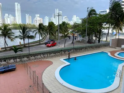 a large swimming pool with a view of a city at Apartamento cerca de playas y zonas turísticas in Cartagena de Indias