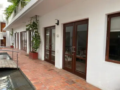 a building with glass doors and a brick walkway at Virrey Eslava 120 Luxury Guesthouse in Cartagena de Indias