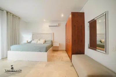 a white bedroom with a bed and a mirror at Virrey Eslava 120 Luxury Guesthouse in Cartagena de Indias