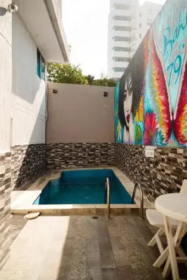 a swimming pool with a painting on the side of a building at Aparta estudio en el edificio bahia 79 apartasuites in Cartagena de Indias