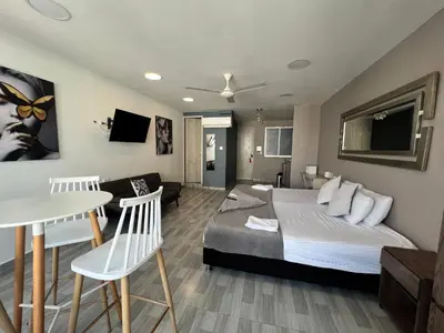 a bedroom with a bed and a living room at Aparta estudio en el edificio bahia 79 apartasuites in Cartagena de Indias