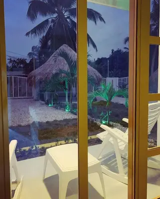 a view of a table and chairs through a window at Bahia Tropical Sandia Kiwi Piña in Coveñas