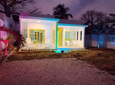 a small house with lights on the front of it at Bahia Tropical Sandia Kiwi Piña in Coveñas