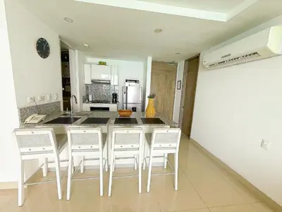 a kitchen with a table with chairs and a refrigerator at 31st Perfect Seaview Bocagrande Morros City in Cartagena de Indias