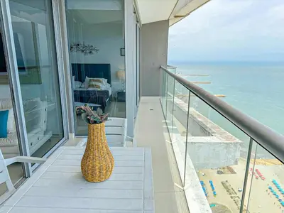 a wicker vase sitting on the stairs of a house at 31st Perfect Seaview Bocagrande Morros City in Cartagena de Indias